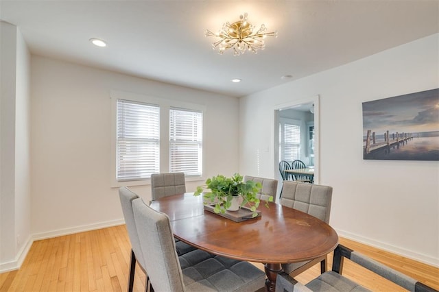 dining space featuring baseboards, light wood finished floors, and recessed lighting