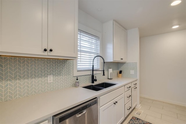 kitchen with white cabinetry, dishwasher, light countertops, a sink, and backsplash
