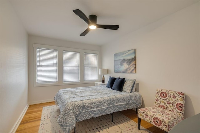 bedroom featuring light wood-type flooring, ceiling fan, and baseboards