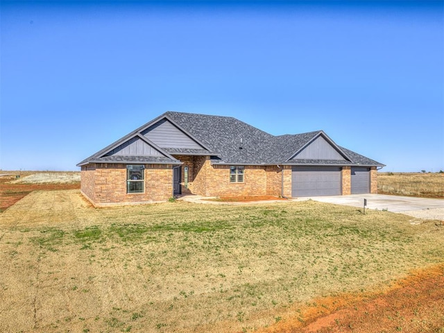 single story home with brick siding, a front yard, a garage, and concrete driveway