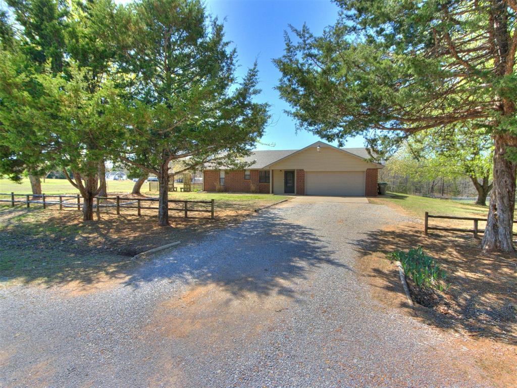 2 James Ray Rd, Shawnee, OK 74801 - ranch-style home featuring driveway, fence, brick siding, and an attached garage