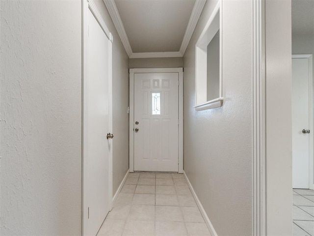 doorway to outside with crown molding, light tile patterned floors, baseboards, and a textured wall