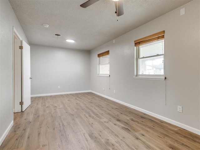 unfurnished room with light wood-style flooring and baseboards