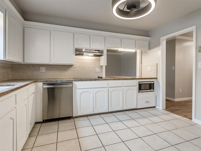 kitchen featuring white cabinetry, light tile patterned flooring, under cabinet range hood, decorative backsplash, and appliances with stainless steel finishes