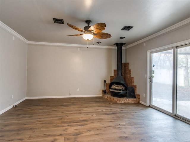 unfurnished living room featuring wood finished floors, ceiling fan, ornamental molding, and visible vents