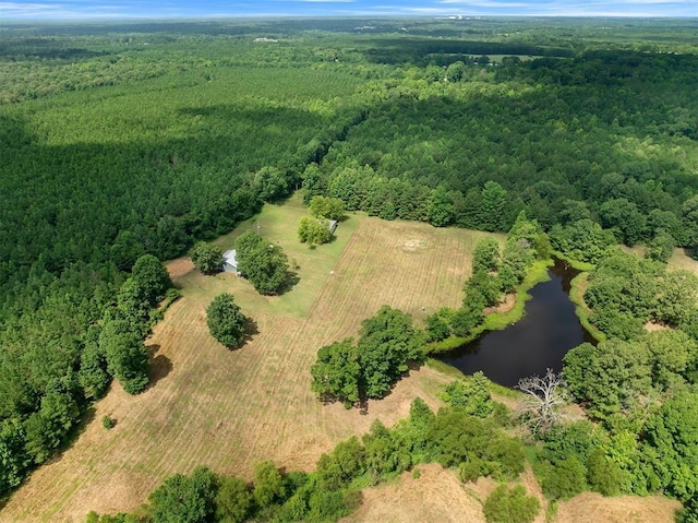 aerial view featuring a wooded view and a water view