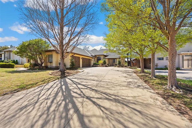 13125 Oakcliff Rd, Oklahoma City, OK 73120 - view of front of property with driveway, stucco siding, a front lawn, a garage, and a residential view