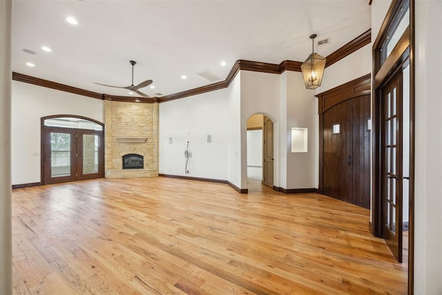 13125 Oakcliff Rd, Oklahoma City, OK 73120 - interior space with ceiling fan, a fireplace, arched walkways, light wood finished floors, and baseboards