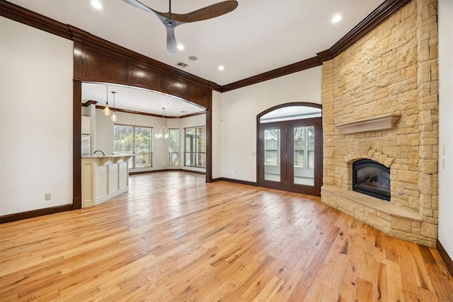 13125 Oakcliff Rd, Oklahoma City, OK 73120 - unfurnished living room with visible vents, baseboards, a stone fireplace, ceiling fan, and light wood finished floors