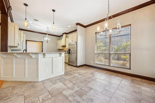 13125 Oakcliff Rd, Oklahoma City, OK 73120 - kitchen with stainless steel fridge with ice dispenser, visible vents, premium range hood, a kitchen bar, and light stone countertops