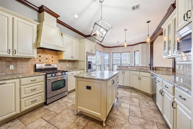 13125 Oakcliff Rd, Oklahoma City, OK 73120 - kitchen featuring ornamental molding, visible vents, premium range hood, and built in appliances