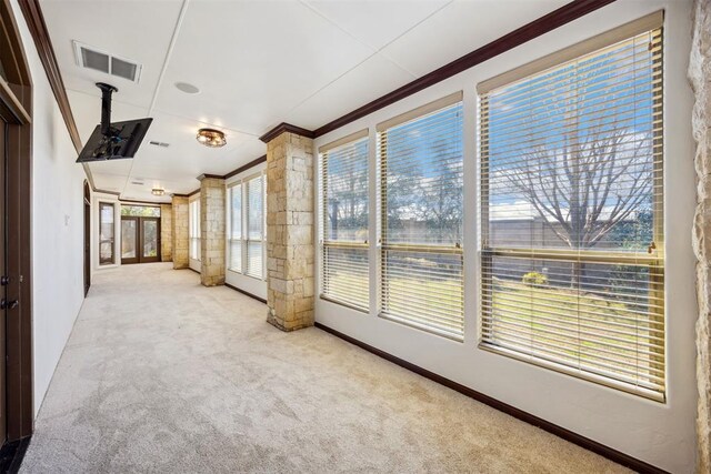 13125 Oakcliff Rd, Oklahoma City, OK 73120 - unfurnished sunroom with a wealth of natural light, visible vents, crown molding, and carpet floors