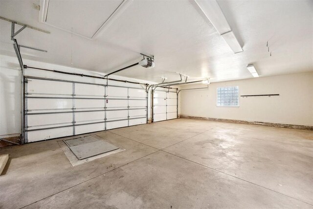 13125 Oakcliff Rd, Oklahoma City, OK 73120 - garage featuring baseboards and a garage door opener