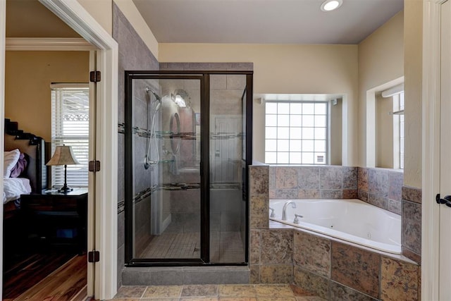 ensuite bathroom with ensuite bath, a shower stall, and a healthy amount of sunlight