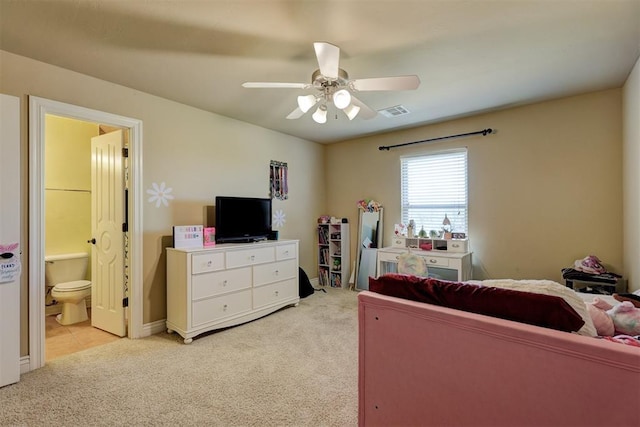 bedroom with a ceiling fan, visible vents, connected bathroom, and light colored carpet