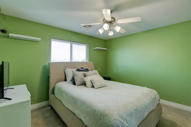 bedroom with visible vents, a ceiling fan, baseboards, and light carpet