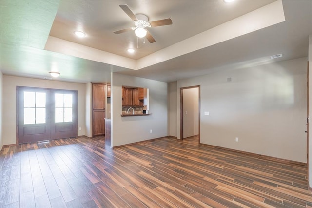 1800 N Nebraska Ave, Oklahoma City, OK 73111 - unfurnished living room with recessed lighting, french doors, a ceiling fan, a tray ceiling, and dark wood finished floors