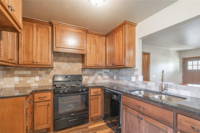 1800 N Nebraska Ave, Oklahoma City, OK 73111 - kitchen with brown cabinets, a sink, black appliances, and dark stone counters