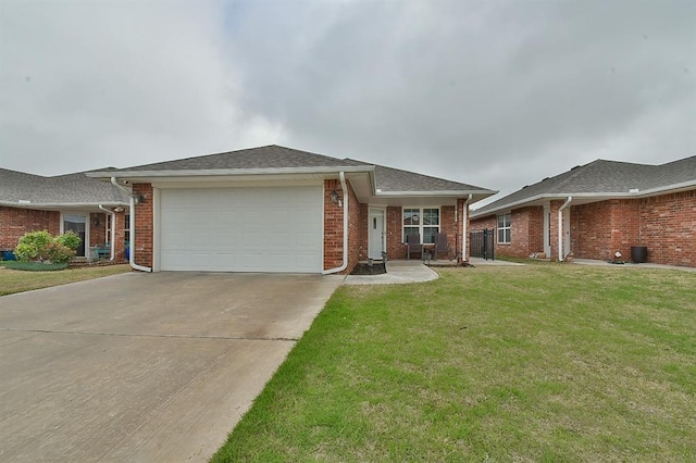 view of front facade featuring a front lawn, brick siding, an attached garage, a shingled roof, and driveway