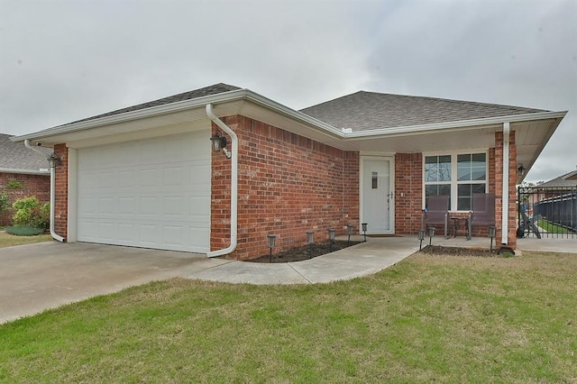 ranch-style home featuring concrete driveway, a front lawn, an attached garage, brick siding, and a shingled roof