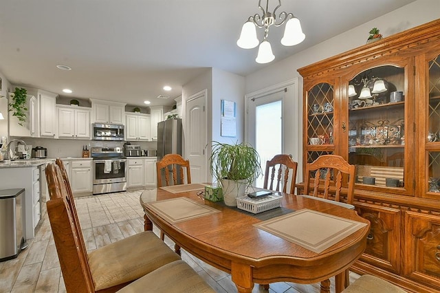 dining space featuring recessed lighting and a notable chandelier