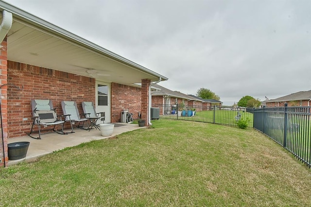view of yard with central air condition unit, a patio, and a fenced backyard