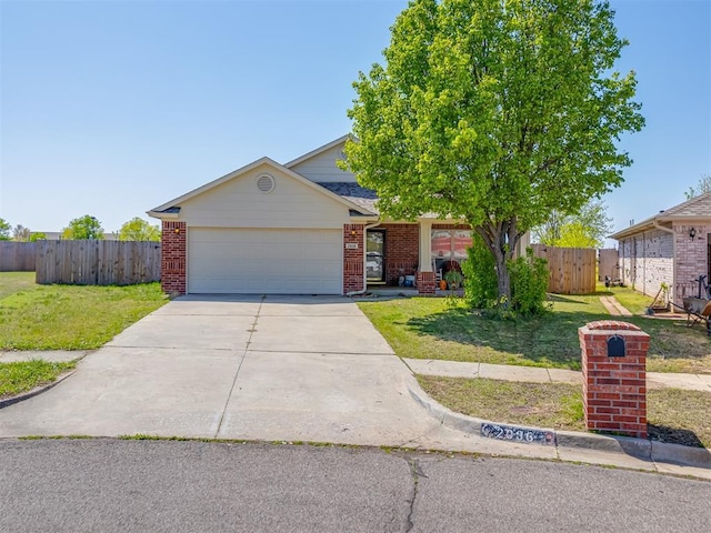 view of front of house featuring a front yard, an attached garage, brick siding, and concrete driveway