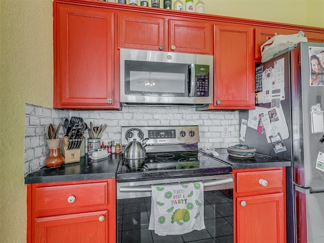 kitchen with dark countertops, decorative backsplash, and appliances with stainless steel finishes