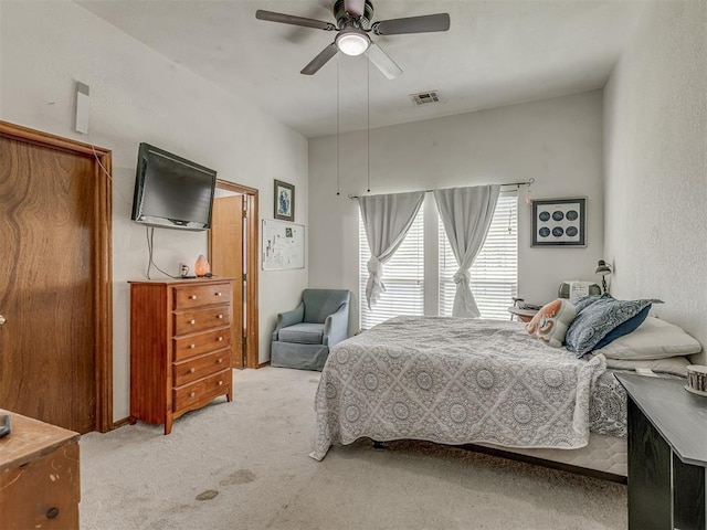 carpeted bedroom with ceiling fan and visible vents