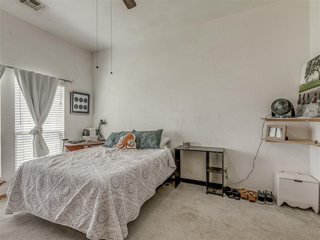 carpeted bedroom with visible vents and a ceiling fan