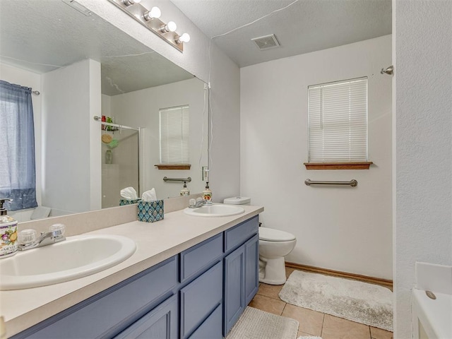 full bath with a stall shower, a sink, visible vents, and tile patterned floors