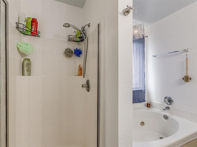 bathroom featuring a shower stall and a jetted tub