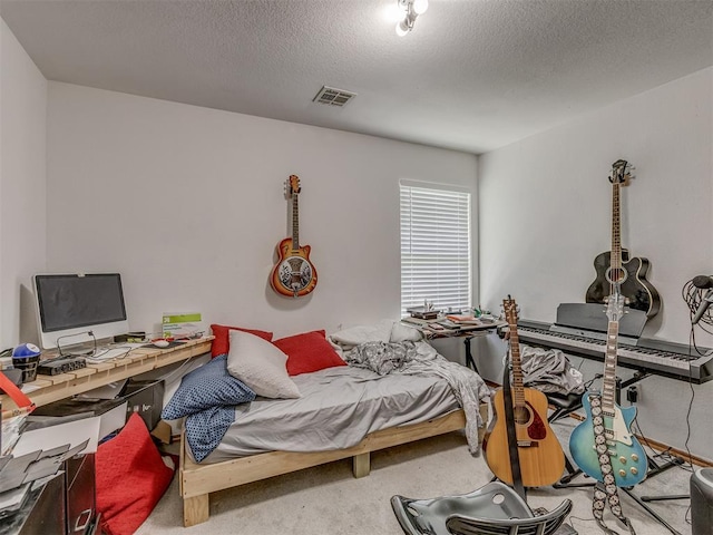 bedroom with a textured ceiling, carpet flooring, and visible vents