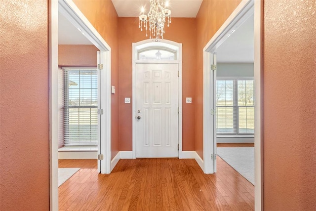 17787 N County Road 3200th Rd, Pauls Valley, OK 73075 - entrance foyer with a chandelier, a healthy amount of sunlight, baseboards, and wood finished floors
