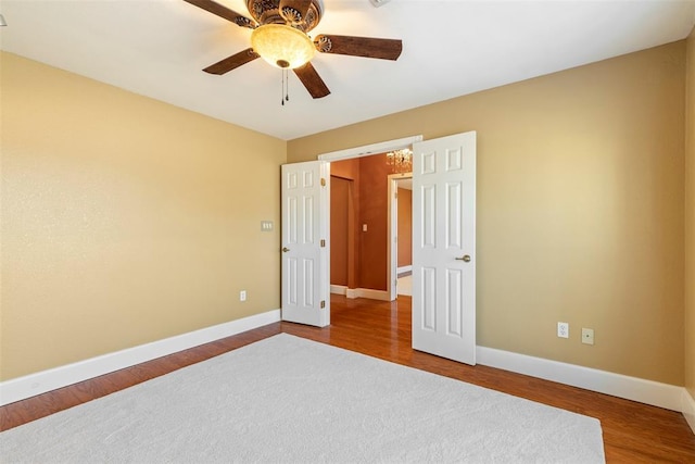 17787 N County Road 3200th Rd, Pauls Valley, OK 73075 - unfurnished bedroom featuring ceiling fan, baseboards, and wood finished floors