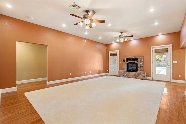 17787 N County Road 3200th Rd, Pauls Valley, OK 73075 - unfurnished living room featuring visible vents, ceiling fan, a fireplace, recessed lighting, and light wood-style flooring