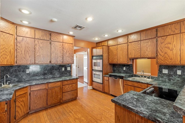 17787 N County Road 3200th Rd, Pauls Valley, OK 73075 - kitchen with a sink, visible vents, brown cabinets, and stainless steel appliances