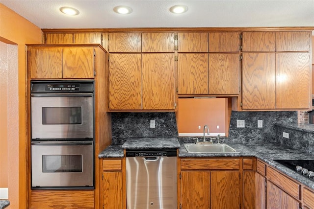17787 N County Road 3200th Rd, Pauls Valley, OK 73075 - kitchen featuring tasteful backsplash, dark countertops, brown cabinets, stainless steel appliances, and a sink