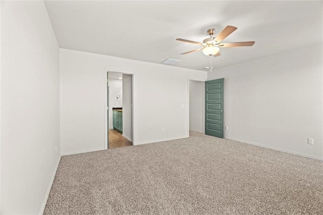 carpeted empty room featuring baseboards and ceiling fan