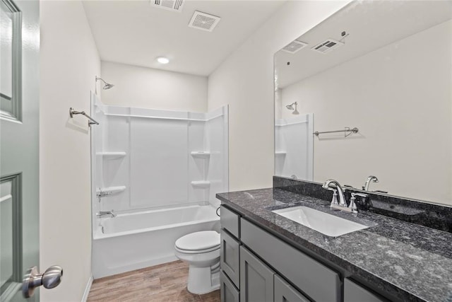 bathroom featuring toilet, vanity, wood finished floors, and visible vents