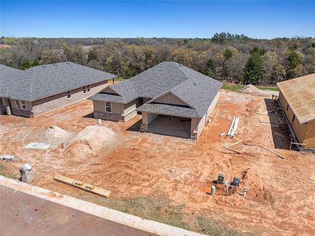 birds eye view of property with a wooded view