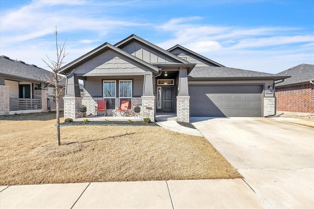 craftsman-style house with a front lawn, driveway, stone siding, a porch, and an attached garage
