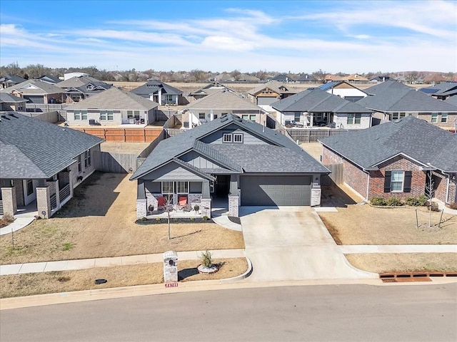 view of front of house with a residential view, driveway, and fence