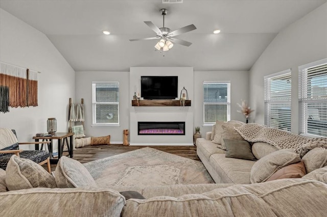 living area featuring vaulted ceiling, wood finished floors, and a wealth of natural light