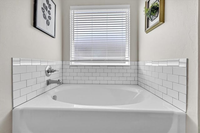 bathroom with a garden tub and a wealth of natural light