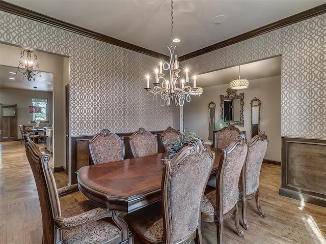 dining area with ornamental molding, wood finished floors, baseboards, wallpapered walls, and a chandelier