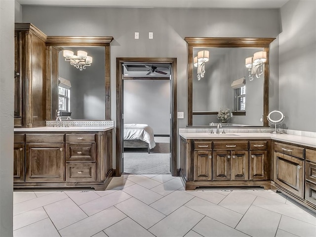 bathroom with vanity, ensuite bathroom, tile patterned floors, and an inviting chandelier
