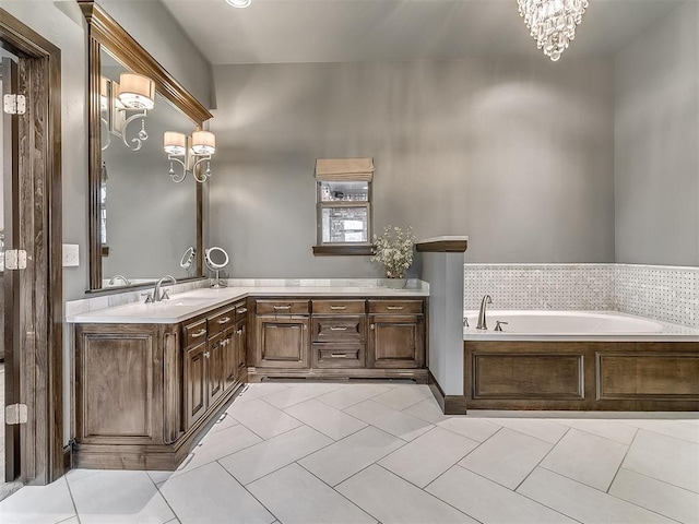 full bathroom featuring a garden tub, tile patterned floors, a notable chandelier, and vanity