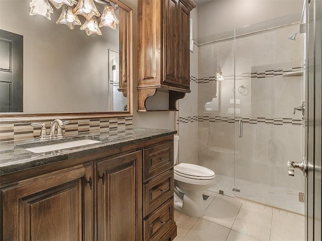 full bathroom with tile patterned flooring, vanity, toilet, decorative backsplash, and a shower stall