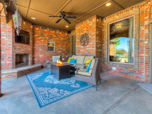 view of patio featuring a ceiling fan and an outdoor living space with a fireplace